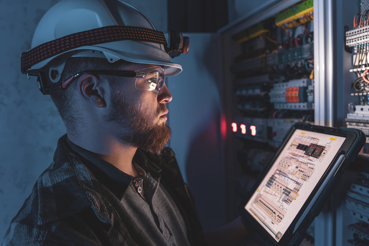 Изображение — electrician overalls focused work switchboard with fuses using tablet 1 (1)